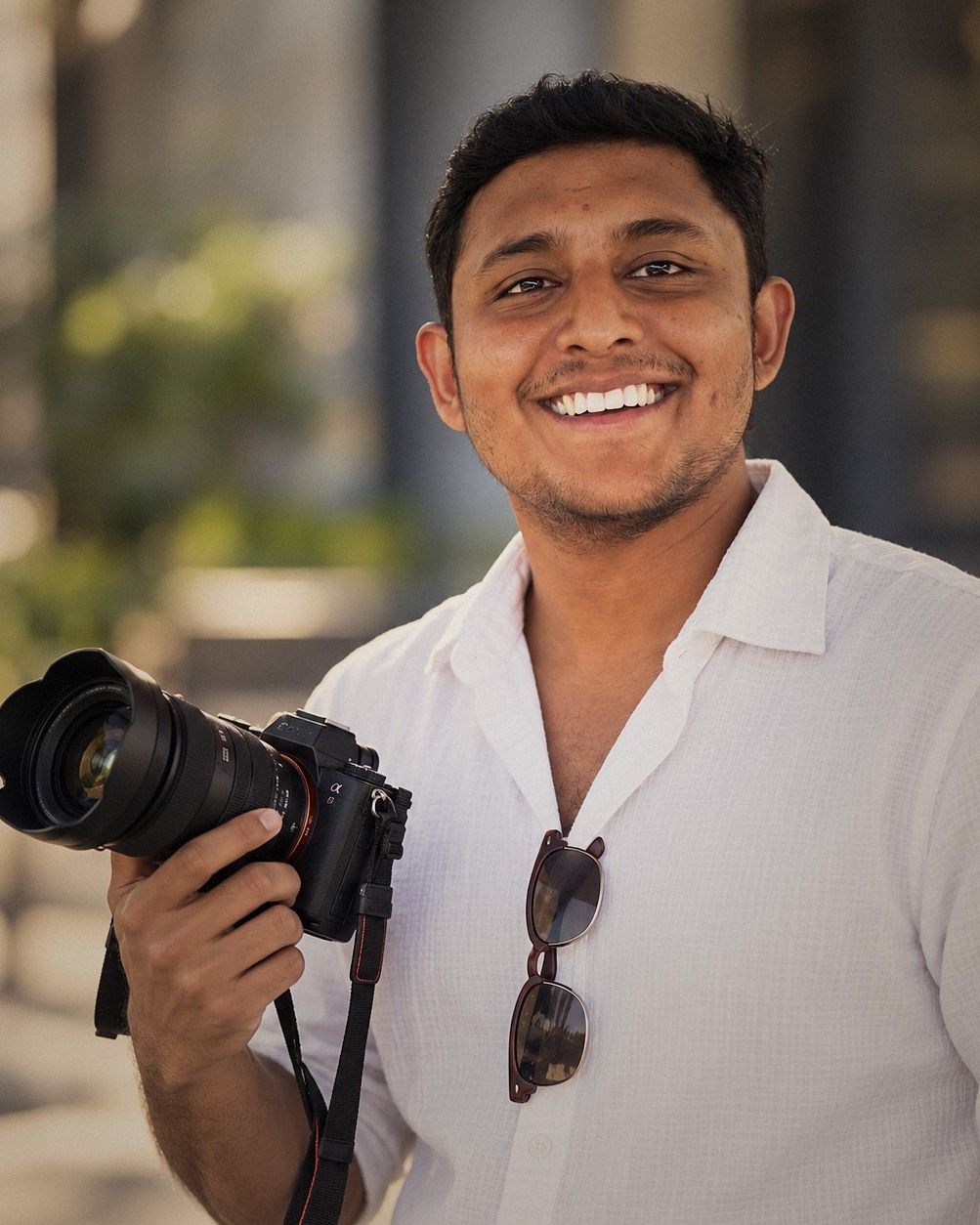 Zaheer Fasly, photographer and videographer behind Pixels with Bliss, holding his camera
